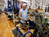 A worker irons the shoulders of a newly made suit jacket,  at the Joseph Abboud manufacturing plant in New Bedford, MA.   [ PETER PEREIRA/THE STANDARD-TIMES/SCMG ]